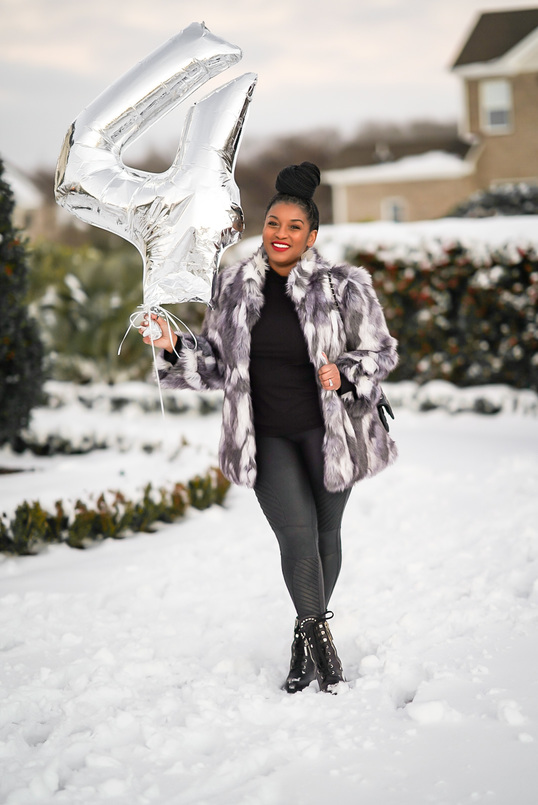 black woman in snow celebrating 4th business anniversary. Tips on how to become an influencer.